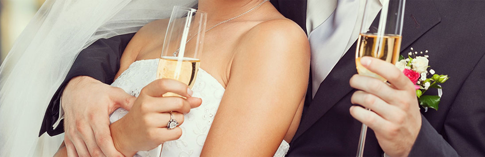 A couple holding champagne at their wedding