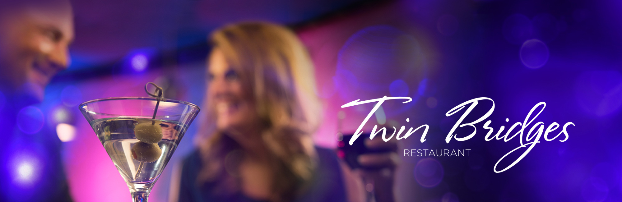 A couple enjoys martinis at Twin Bridges Restaurant